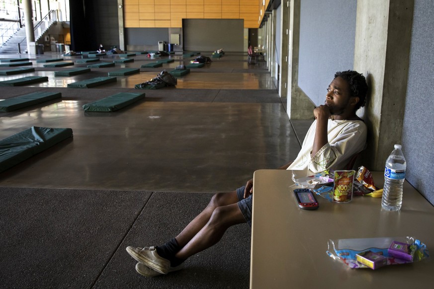 Carlitos, 24, came to the cooling center at Fisher Pavilion in the Seattle Center Saturday night after experiencing symptoms of heat exhaustion during a record-breaking heat wave Sunday June 27, 2021. ...