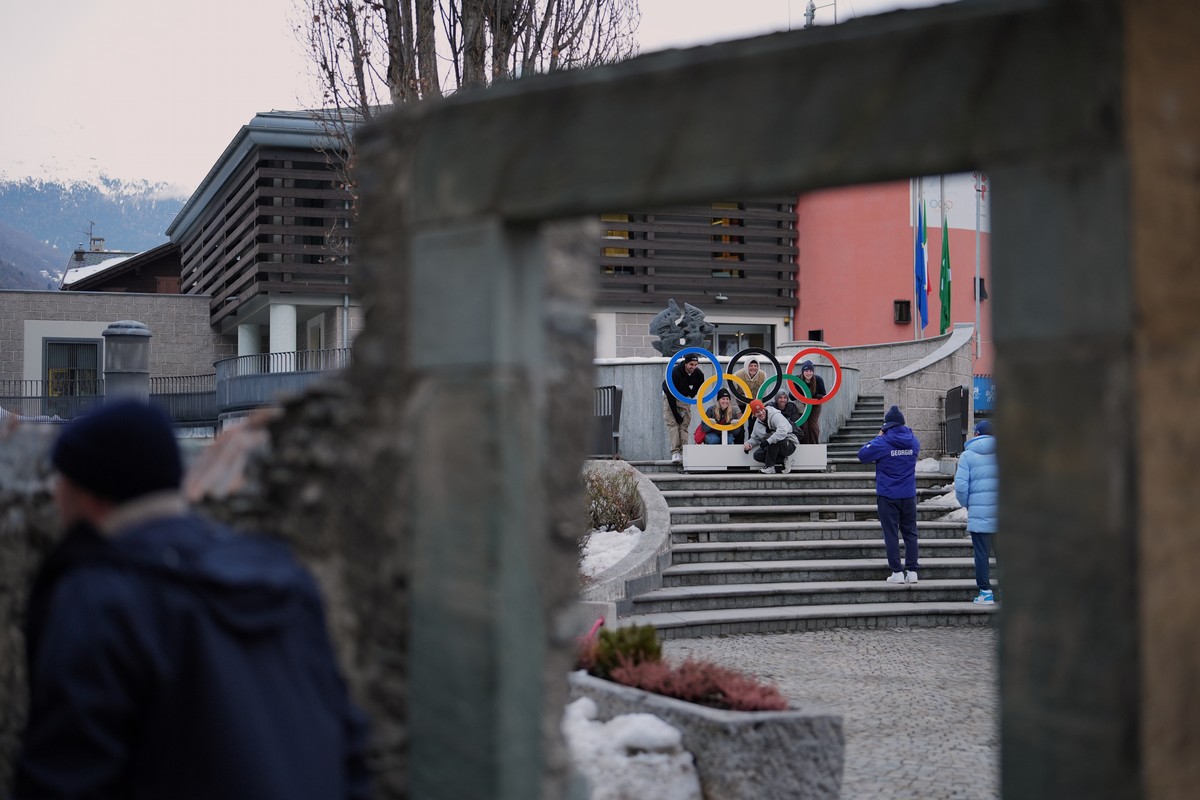 People pose for pictures next to Olympic rings in Bormio, Italy, during the 2026 Winter Olympics, Tuesday, Feb. 10, 2026. (AP Photo/Rebecca Blackwell)
Milan Cortina Olympics