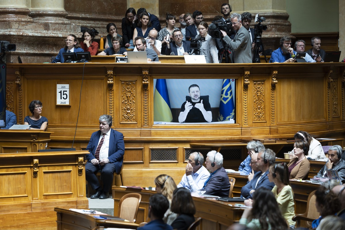 Ukrainian President Volodymyr Zelensky is displayed on a screen during his speech to the members of the Swiss parliament, in Bern, Switzerland, Thursday, June 15, 2023. (KEYSTONE/Peter Klaunzer)
