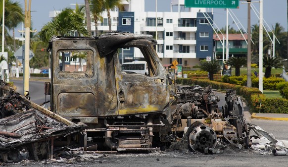epaselect epa12772352 Burned out vehicles are seen on the boardwalk in Puerto Vallarta, Mexico, 23 February 2026. The resort city reports visible disruptions after violence linked to the killing of dr ...