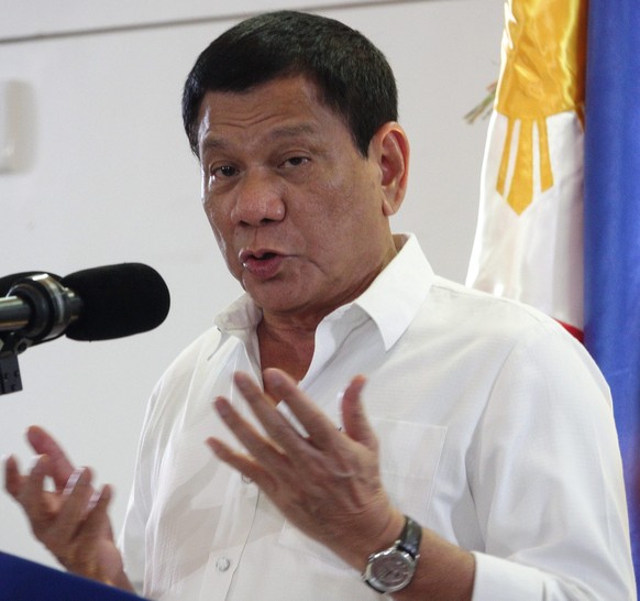 epa05679103 Philippine President Rodrigo Duterte speaks to members of the media during his arrival at Davao City&#039;s international airport, southern Philippines, 17 December 2016. Duterte returned  ...