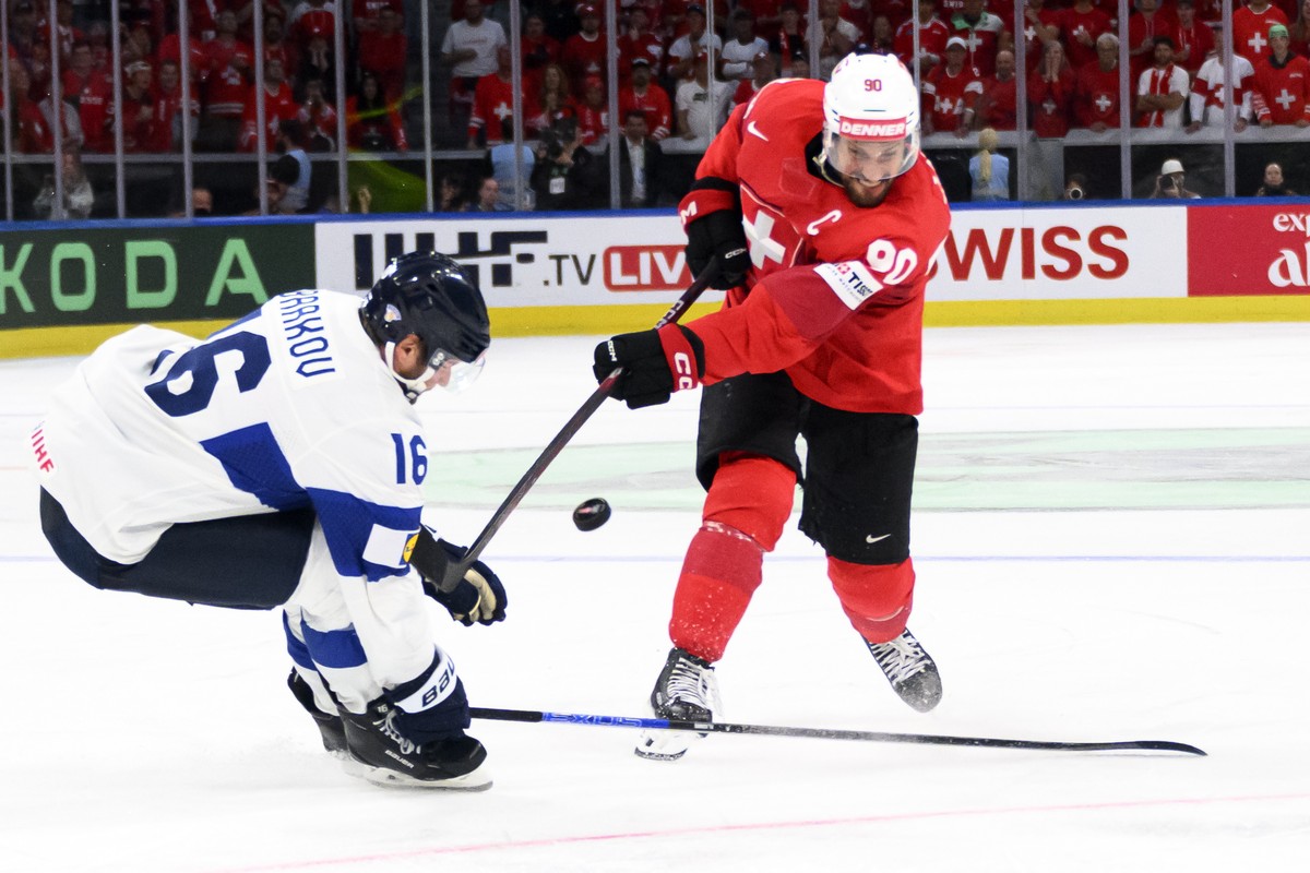 epa13007585 Finland's Aleksander Barkov (L) in action against Switzerland's Roman Josi (R) during the 2026 IIHF Men's Ice Hockey World Championship gold medal game between Switzerland a ...