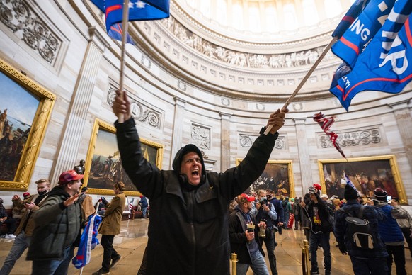 epa09623644 Supporters of US President Donald J. Trump in the Capitol Rotunda after breaching Capitol security in Washington, DC, USA, 06 January 2021. Protesters entered the US Capitol where the Elec ...