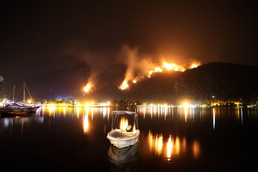Fire fighters work to stop forest fires near Orhaniye village at Marmaris, mediterranean coastal city in Antalya. More than 133 wildfires have broken out this week in provinces on Turkey s Aegean and  ...