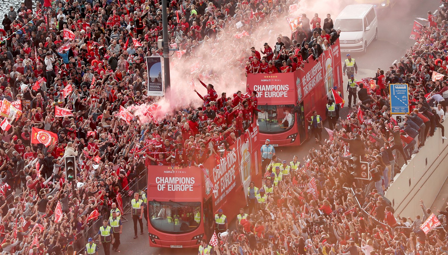 epa07620955 Liverpool supporters greet the team during the Liverpool victory parade in Liverpool, Britain, 02 June 2019. Liverpool FC won the UEFA Champions league final against Tottenham Hotspurs at  ...