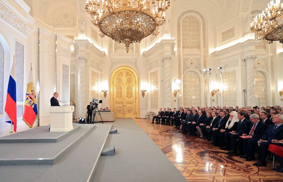 Russian President Vladimir Putin, left, gives his annual state of the nation address in the Kremlin in Moscow, Russia, Thursday, Dec. 1, 2016. Speaking in his live state-of-the-nation address, Putin p ...