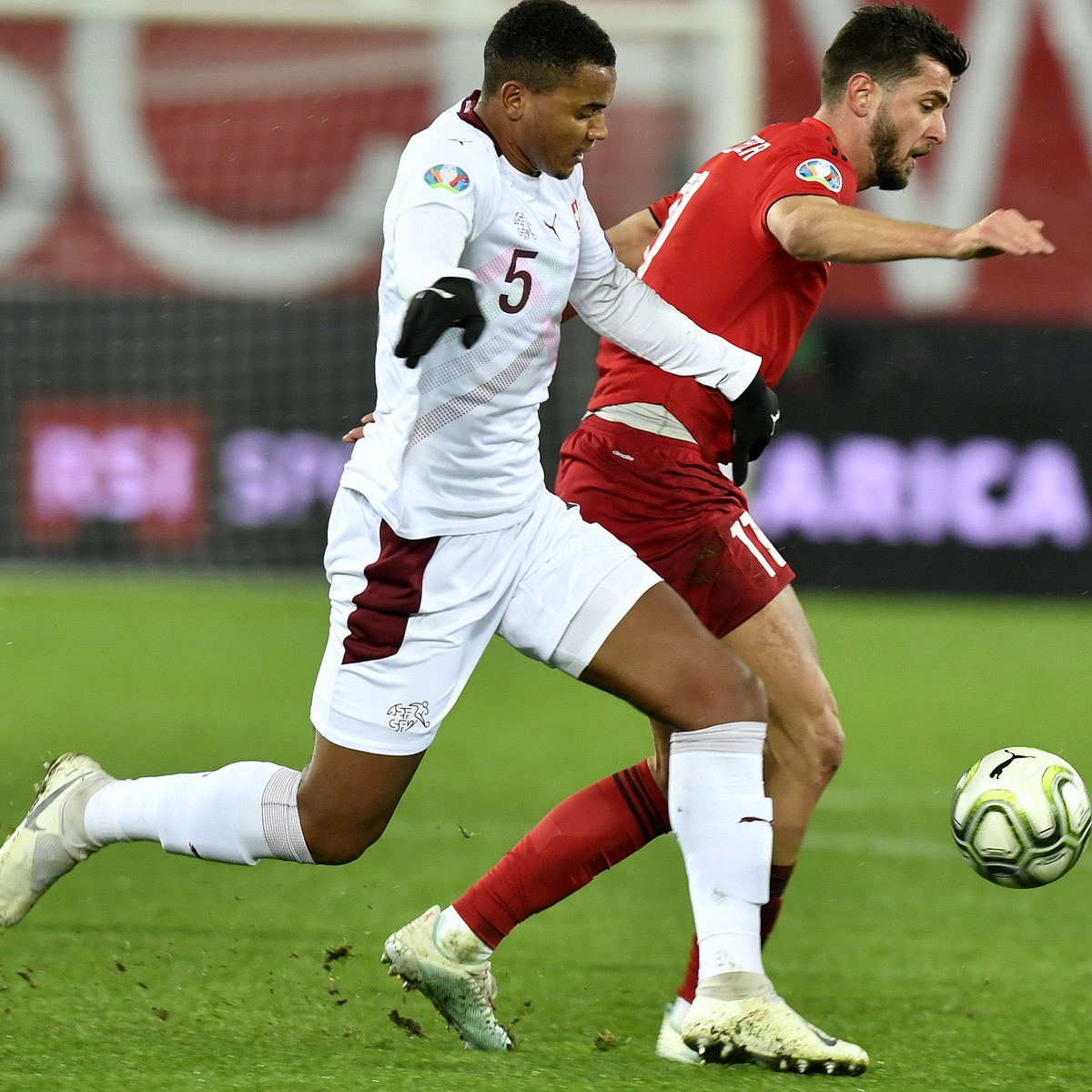 Switzerland's Manuel Akanji, left, against Georgia's Giorgi Kvilitaia, right, during the UEFA Euro 2020 qualifying Group D soccer match between Switzerland and Georgia at the Kybunpark stadi ...