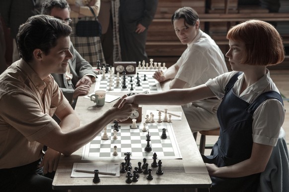 This image release by Netflix shows Jacob Fortune-Lloyd, left, and Anya Taylor-Joy from the series &quot;The Queen&#039;s Gambit.&quot; (Phil Bray/Netflix via AP)