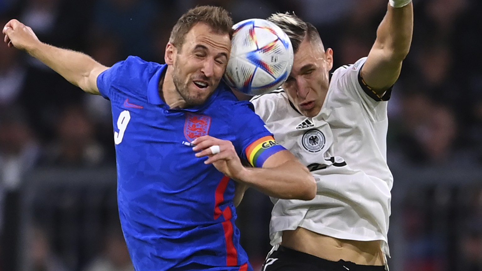England&#039;s Harry Kane, left, challenges for the ball with Germany&#039;s Nico Schlotterbeck during the UEFA Nations League soccer match between Germany and England at the Allianz Arena, in Munich, ...