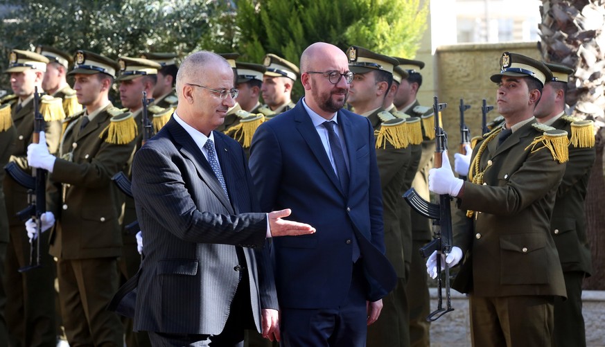 epa05776285 Belgian Prime Minister Charles Michel (R) and Palestinian Prime Minister Rami Hamdallah (L) review the honor guards during a welcoming ceremony in the West Bank city of Ramallah, 07 Februa ...