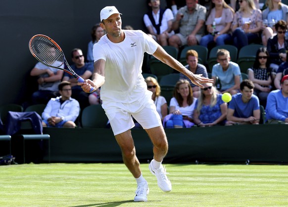 Croatia&#039;s Ivo Karlovic returns a ball to Britain&#039;s Aljaz Bedene during their Men&#039;s Singles Match on day one at the Wimbledon Tennis Championships in London Monday, July 3, 2017. (Gareth ...