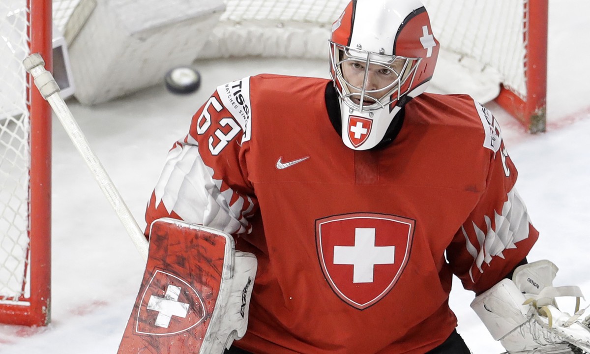 Switzerland's goalie Leonardo Genoni looks the puck during the Ice Hockey World Championships final match between Sweden and Switzerland at the Royal arena in Copenhagen, Denmark, Sunday, May 20, ...