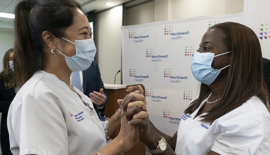 Nurse Annabelle Jimenez, left, congratulates nurse Sandra Lindsay after she was inoculated with the Pfizer-BioNTech COVID-19 vaccine, Monday, Dec. 14, 2020, at the Jewish Medical Center, in the Queens ...