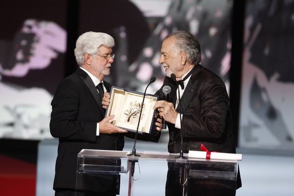 epa11370048 George Lucas (L) accepts the Honorary Palme D&#039;Or Award from Francis Ford Coppola (R) during the closing and awards ceremony of the 77th annual Cannes Film Festival, in Cannes, France, ...