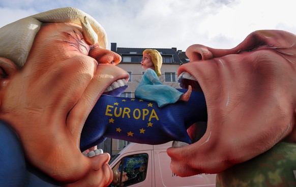 epa12746385 A carnival float built by float builder Jacques Tilly, titled 'Europa verschlucken,' depicting Russian President Vladimir Putin (R) and US President Donald Trump (L), is ready fo ...