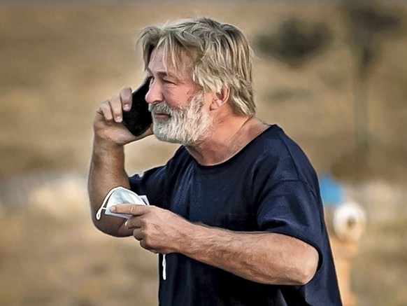 Alec Baldwin speaks on the phone in the parking lot outside the Santa Fe County Sheriff&#039;s Office in Santa Fe, N.M., after he was questioned about a shooting on the set of the film &quot;Rust&quot ...