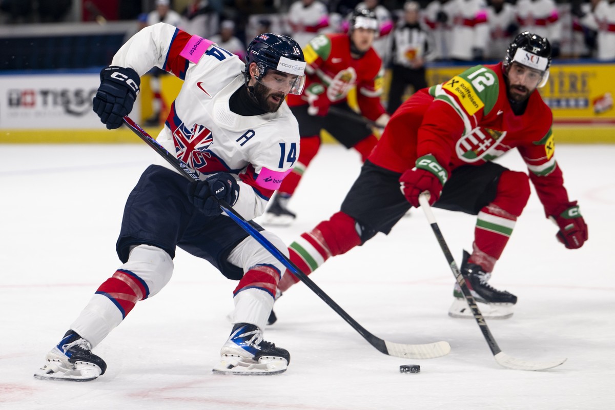 Great Britain's Liam Kirk, left, vies for the puck against Bence Stipsicz, right, during the 2026 IIHF Men's Ice Hockey World Championship preliminary round group A game between Hungary and  ...