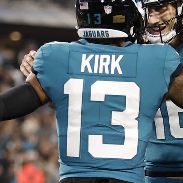 JACKSONVILLE, FL - JANUARY 07: Jacksonville Jaguars quarterback Trevor Lawrence 16 celebrates a touchdown with Jacksonville Jaguars wide receiver Christian Kirk 13 during the game between the Tennesse ...