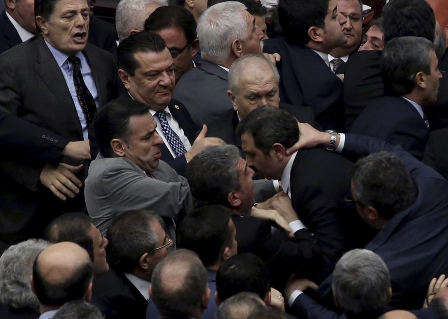 Ruling Justice and Development Party and main opposition Republican People&#039;s Party legislators scuffle in Turkey&#039;s parliament during deliberations over a controversial package of constitutio ...