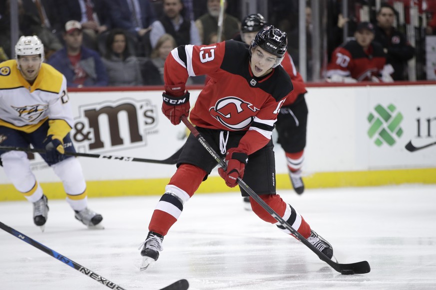 New Jersey Devils center Nico Hischier (13), of Switzerland, shoots against the Nashville Predators during the second period of an NHL hockey game, Thursday, Jan. 25, 2018, in Newark, N.J. (AP Photo/J ...