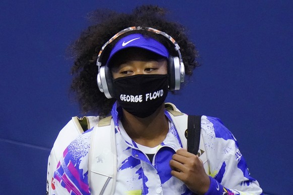 FILE - In this Sept. 8, 2020, file photo, Naomi Osaka, of Japan, wears a protective mask due to the COVID-19 virus outbreak, featuring the name &quot;George Floyd&quot;, while arriving on court to fac ...