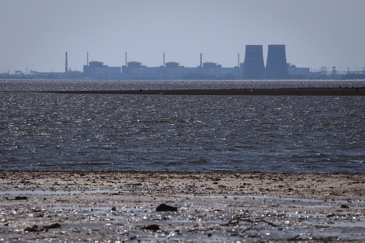 FILE - The Zaporizhzhia nuclear power plant, Europe's largest, stands in the background of the shallow Kakhovka Reservoir after the dam collapse, in Energodar, Russian-occupied Ukraine, June 9, 2 ...