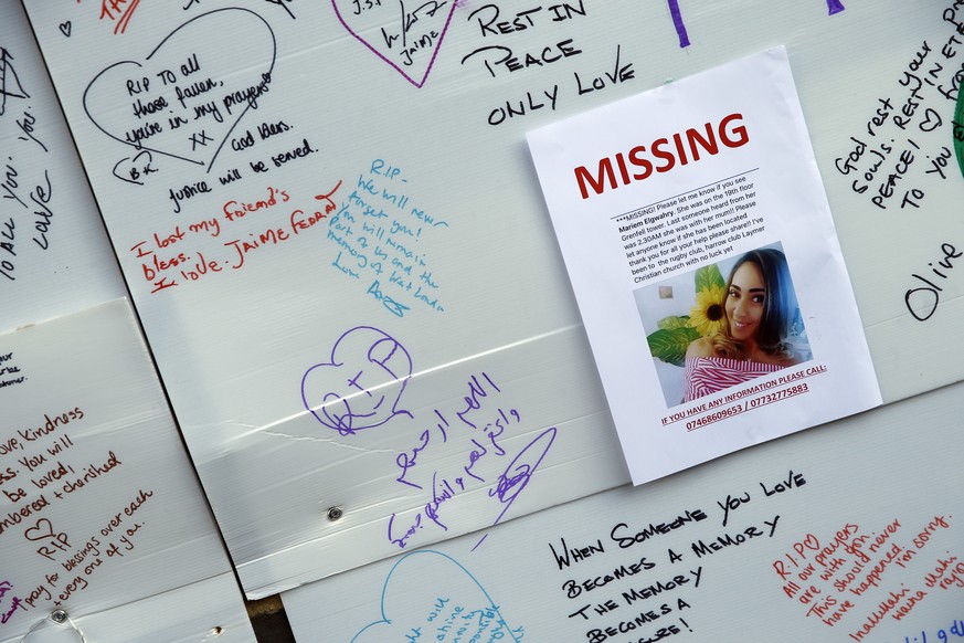 A schoolgirl looks at messages of support for victims, missing and those affected by the massive fire in Grenfell Tower, in London, Thursday, June 15, 2017. A massive fire raced through the 24-story h ...