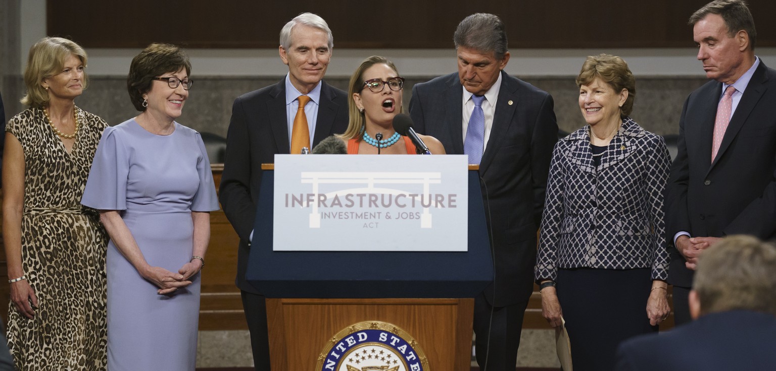 The bipartisan group of Senate negotiators speak to reporters just after a vote to start work on a nearly $1 trillion bipartisan infrastructure package, at the Capitol in Washington, Wednesday, July 2 ...