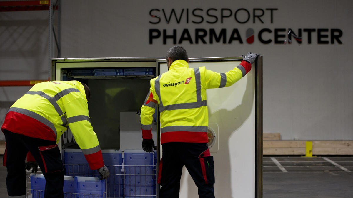 Cargo workers demonstrate the cold chain process for the handling of medicines and vaccines as they place cooling units into a temperature controlled shipping box from a refrigerated warehouse at Swis ...