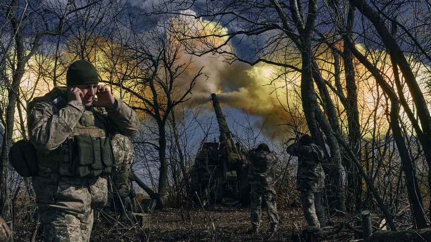Ukrainian soldiers fire a self-propelled howitzer towards Russian positions near Bakhmut, Donetsk region, Ukraine, Sunday, March 5, 2023. (AP Photo/Libkos)