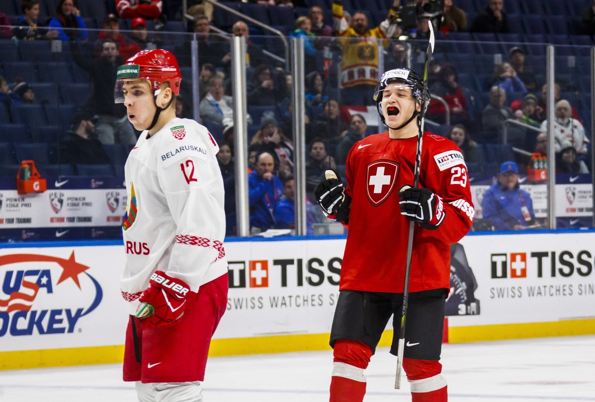 Switzerland's Philipp Kurashev celebrates his goal behind Belarus' Igor Martynov during the third period of IIHF World Junior Championship preliminary round hockey game action in Buffalo, N. ...