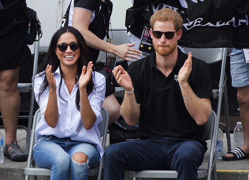 Prince Harry and his girlfriend Meghan Markle applaud at the wheelchair tennis competition at the Invictus Games in Toronto on Monday, Sept. 25, 2017. (Nathan Denette/The Canadian Press via AP)