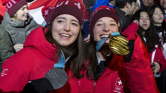 Silver medal winner Mathilde Gremaud of Switzerland, left, and Gold medal winner Sarah Hoefflin of Switzerland, right, celebrate at the House of Switzerland after the women Freestyle Skiing Slopestyle ...