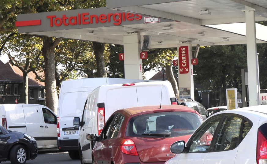 Drivers line up at a petrol station in Roubaix, northern France, Wednesday, Oct. 12, 2022. The French government on Wednesday started the process of requisitioning workers at petrol depots of ExxonMob ...
