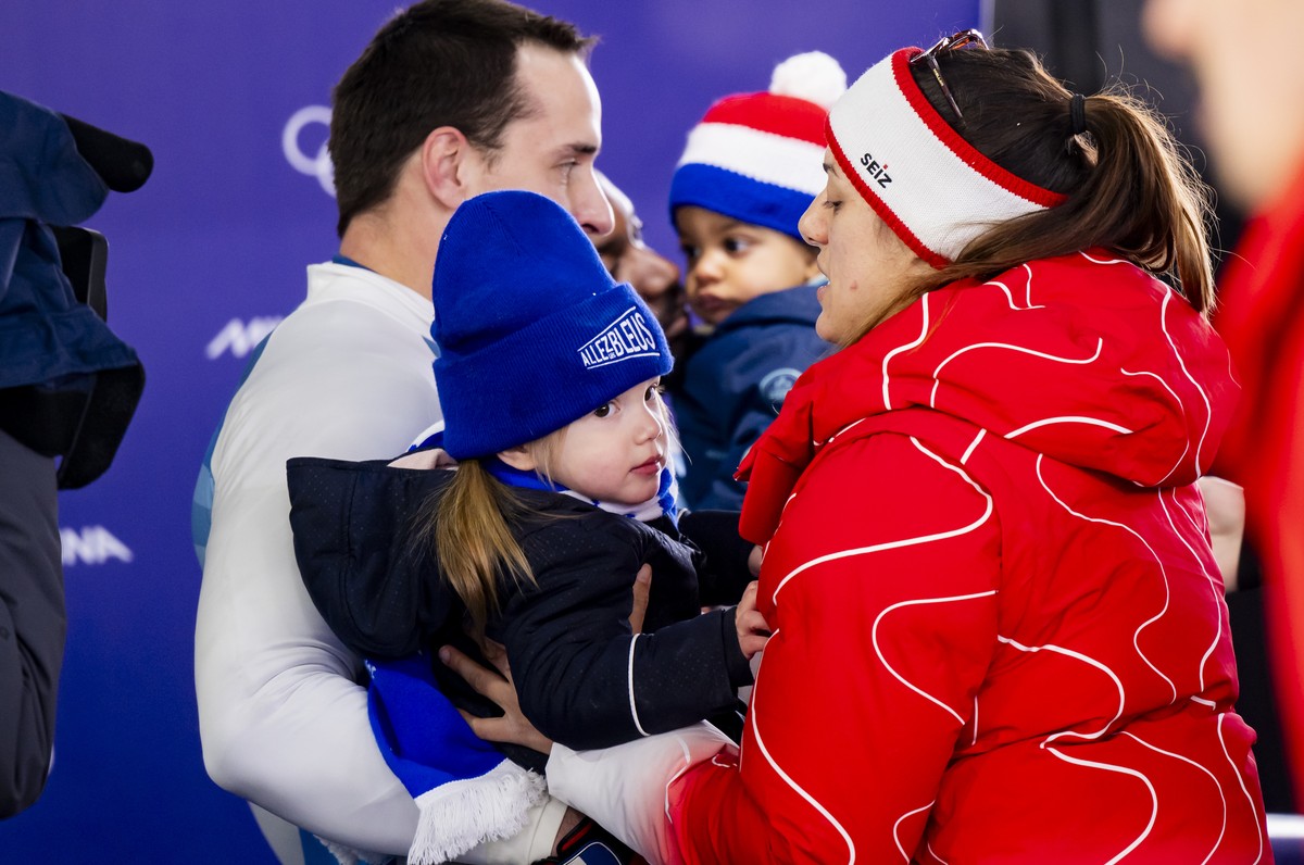 Pilot Romain Heinrich of France reacts in the finish area with Noelie, the girl he has with the pusher Nadja Pasternack of Switzerland during the men's two man bobsled heat 2 at the 2026 Olympic  ...