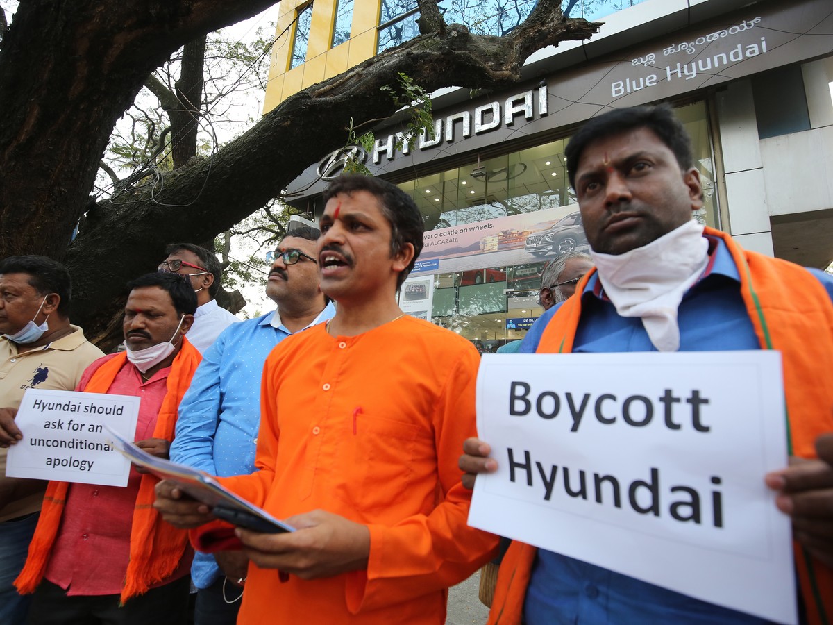 epa09738797 Members of the Hindu Janajagruthi Samiti hold placards during a protest in front of the Hyundai showroom in Bangalore, India, 08 February 2022. The protesters claim Hyundai Pakistan wrote  ...