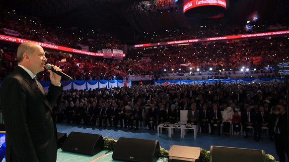 epa06714866 A handout photo made available by the Turkish Presidential Press Office on 06 May 2018 shows Turkish President Recep Tayyip Erdogan (L) delivering a speech during the Istanbul ordinary con ...