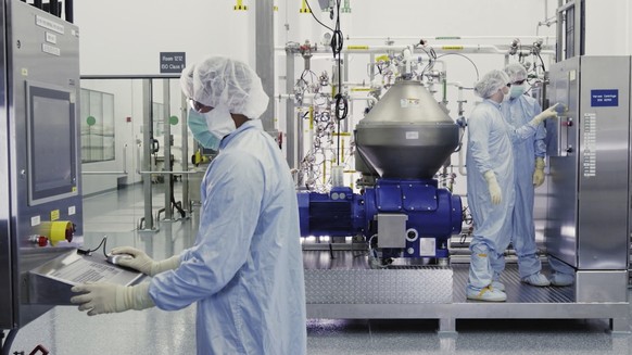 FILE - In this undated image from video provided by Regeneron Pharmaceuticals on Friday, Oct. 2, 2020, scientists work with a bioreactor at a company facility in New York state, for efforts on an expe ...