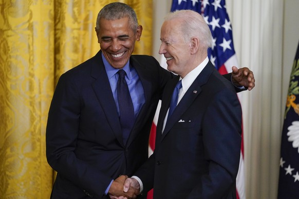 President Joe Biden and former President Barack Obama shake stand together on stage during an event about the Affordable Care Act, in the East Room of the White House in Washington, Tuesday, April 5,  ...