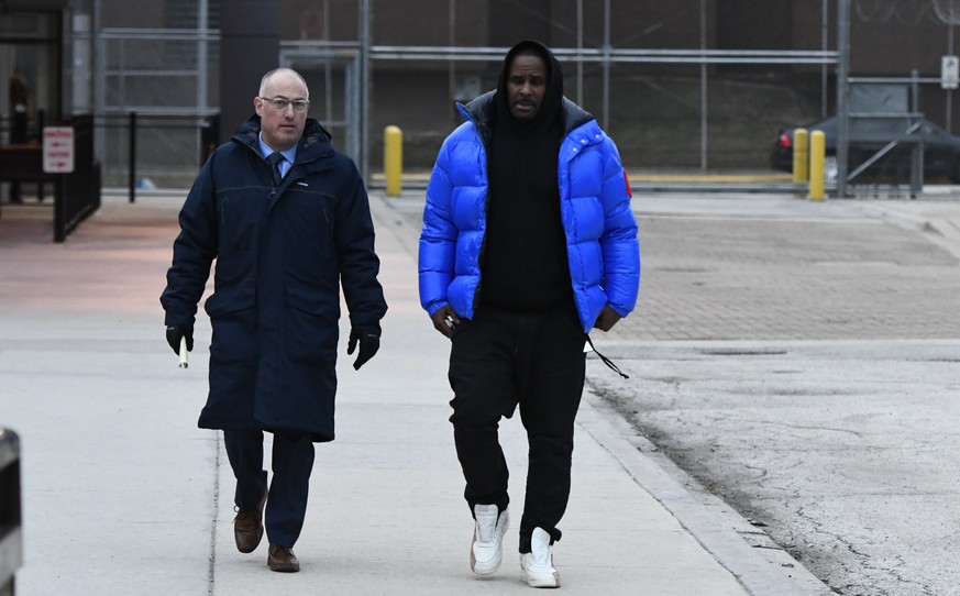 R. Kelly, right, leaves Cook County Jail with his defense attorney, Steve Greenberg, Monday, Feb. 25, 2019, in Chicago. Kelly has been released from jail in Chicago, three days after being booked on c ...