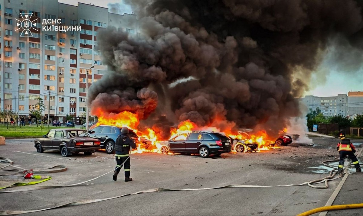 In this photo provided by the Ukrainian Emergency Service, cars burn as firefighters try to put out a fire following a Russian drone attack in Kyiv region, Ukraine, Friday, Aug. 28, 2026. (Ukrainian E ...