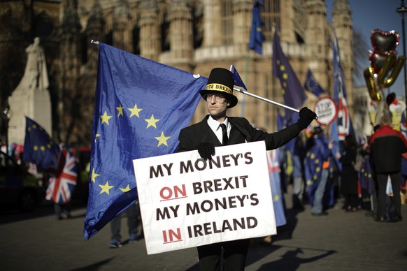 Remain in the European Union supporter Charlie Rome, aged 35 from London and dressed as British pro-Brexit politician Jacob Rees-Mogg poses for photographs outside the Houses of Parliament in London,  ...