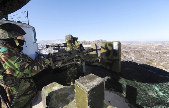 FILE - In this Dec. 19, 2011, file photo, South Korean army soldiers stand guard after a news reporting about the death of North Korean leader Kim Jong Il at a guard post in the demilitarized zone bet ...