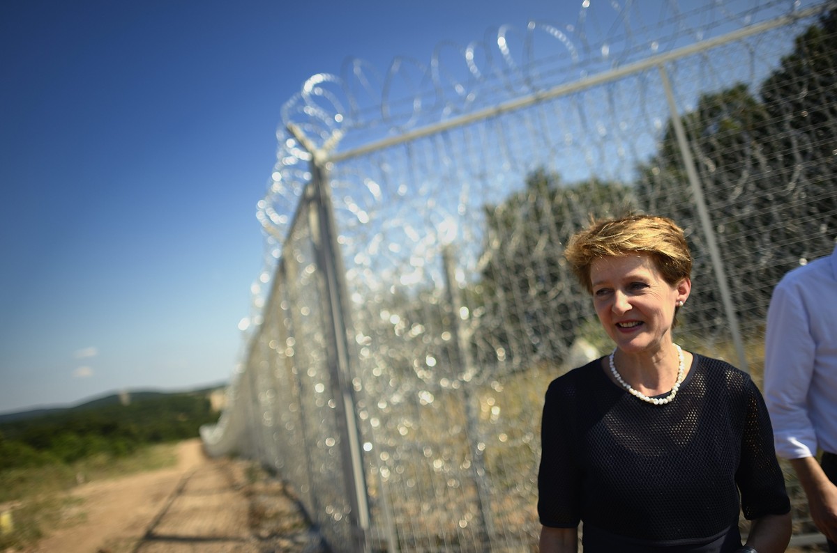epa04303905 Switzerland's Justice minister Simonetta Sommaruga stands in front of a newlt installed security fence at the border between Turkey and Bulgaria during her visit in the town of Elhovo ...