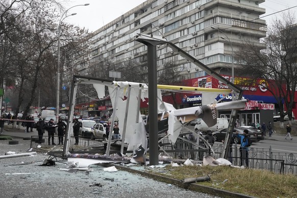 Police investigate the consequences of Russian shelling in Kyiv, Ukraine, Thursday, Feb. 24, 2022. Russian troops have launched their anticipated attack on Ukraine. Big explosions were heard before da ...