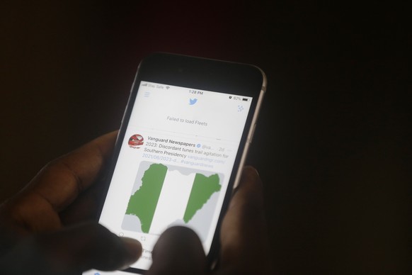 A man used his mobile phone to read headline news on Twitter inside an office in Lagos, Nigeria, Monday June 7, 2021. Nigeria&#039;s government announced on Friday that it was suspending Twitter indef ...