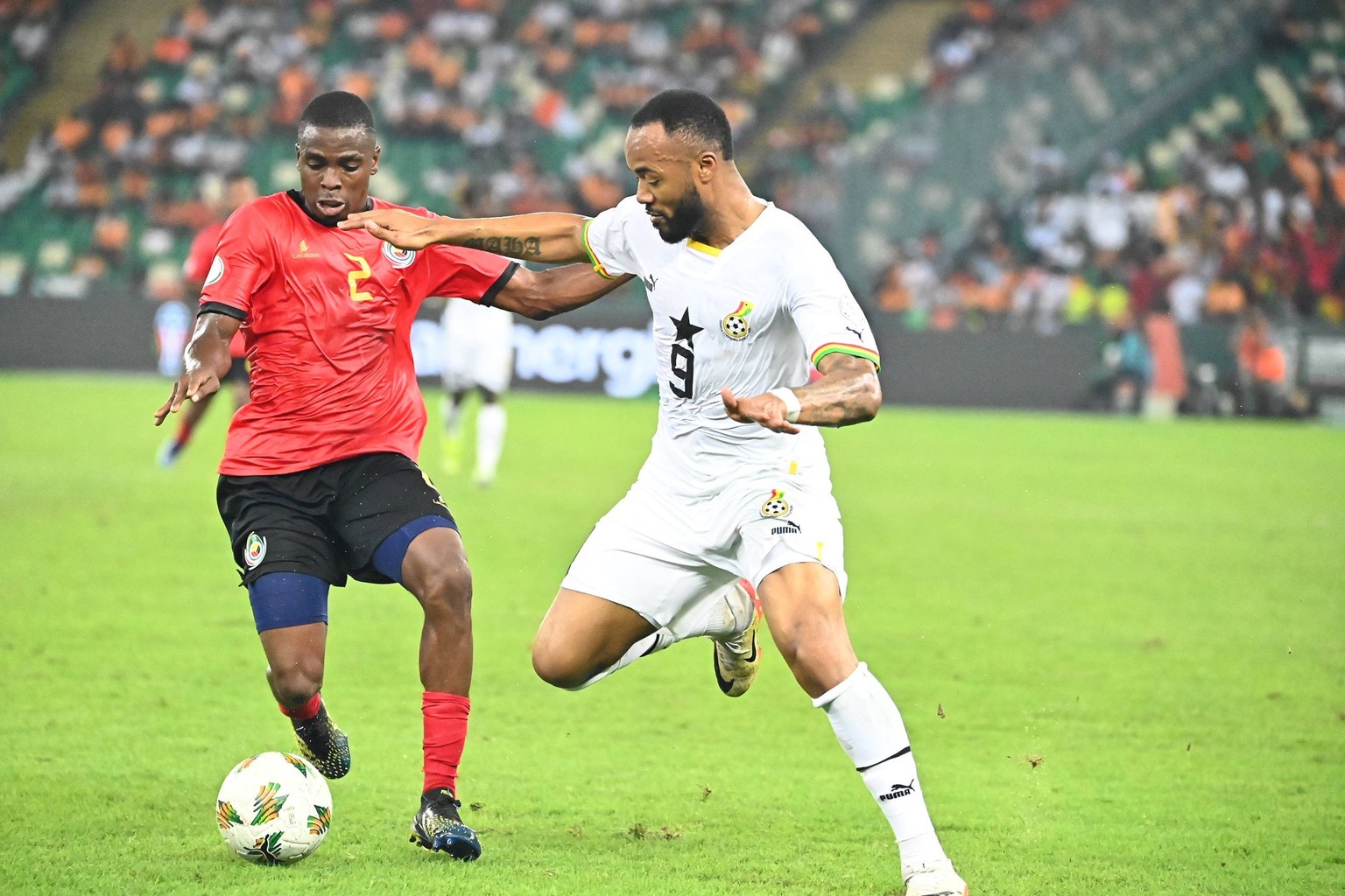 January 22, 2024. AFCON 2023 Jordan Ayew and Nanani in contention for the ball, Mozambique vs Ghana, Stade Olympique Alhassane Ouattara, Abidjan, Cote D Ivoire - Photo by Ebenezer Amoakoh Photogod