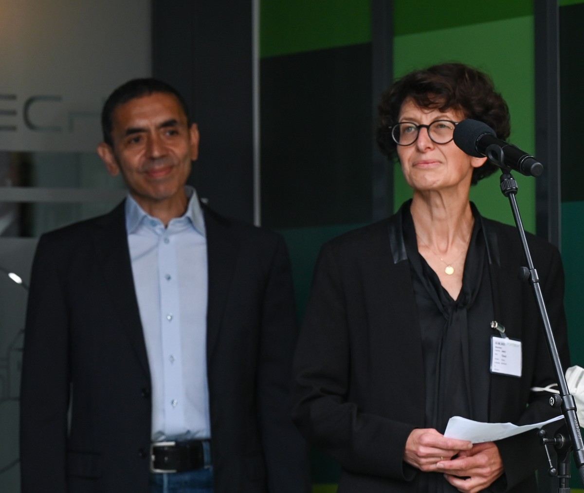 epa09420432 (L-R) German Chancellor Angela Merkel, and BioNTech co-founders Ugur Sahin and Ozlem Tureci during a visit to the Biontech vaccine plant in Marburg, Germany, 19 August 2021. The Marburg pl ...
