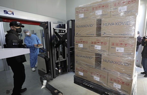 A worker moves boxes carrying Novavax Inc.&#039;s COVID-19 vaccine at SK Bioscience Co. in Andong, South Korea, on Feb. 9, 2022. South Korea will begin offering Novavax Inc.&#039;s COVID-19 vaccine at ...