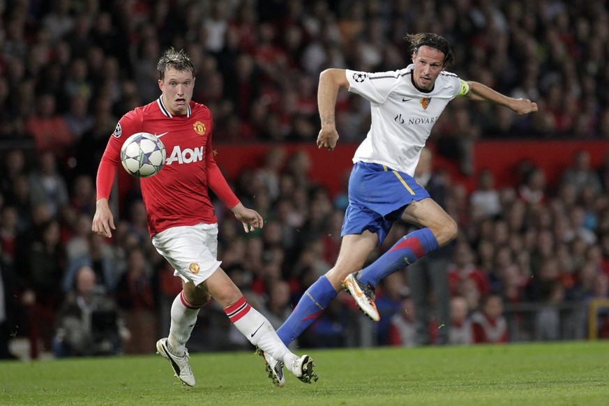 Basel's Marco Streller, right, shoots to goal in front of Manchester's Phil Jones, left, during the UEFA Champions League, Group C, soccer match between Manchester United FC and FC Basel, at the Old T ...
